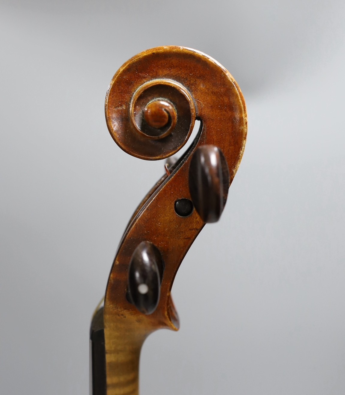 A cased late 19th century English violin, inscribed W. Heaton maker 1887 (?), back measures 35.5cm excl button